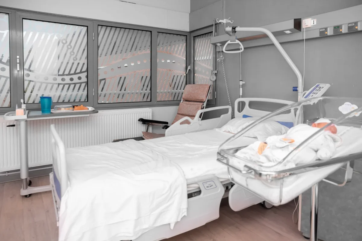 Hospital maternity room with a newborn sleeping in a bassinet